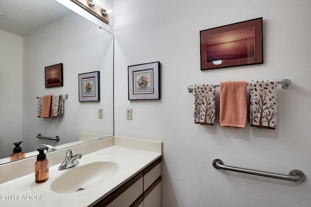 bathroom with a textured ceiling and vanity