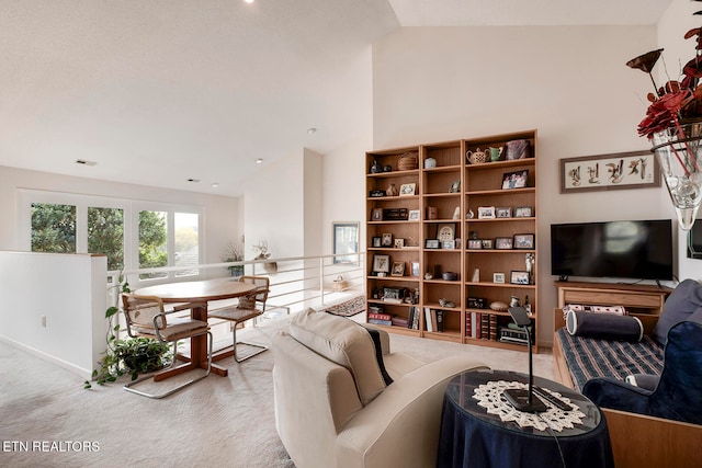 living room featuring light carpet and high vaulted ceiling