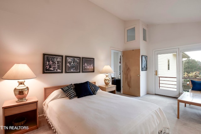 bedroom with access to exterior, high vaulted ceiling, and light carpet