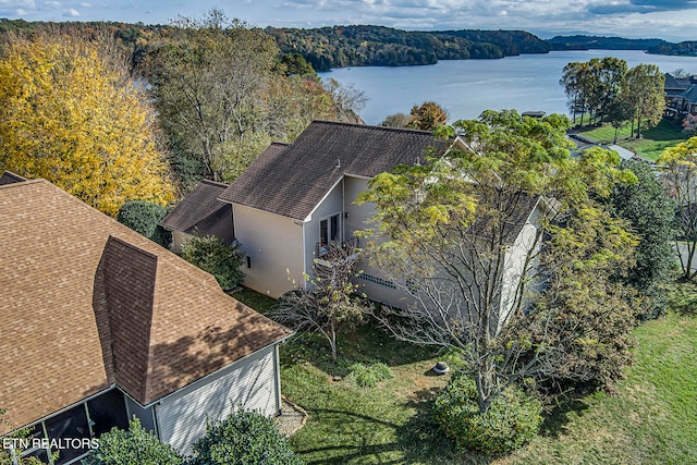 drone / aerial view with a water view and a view of trees