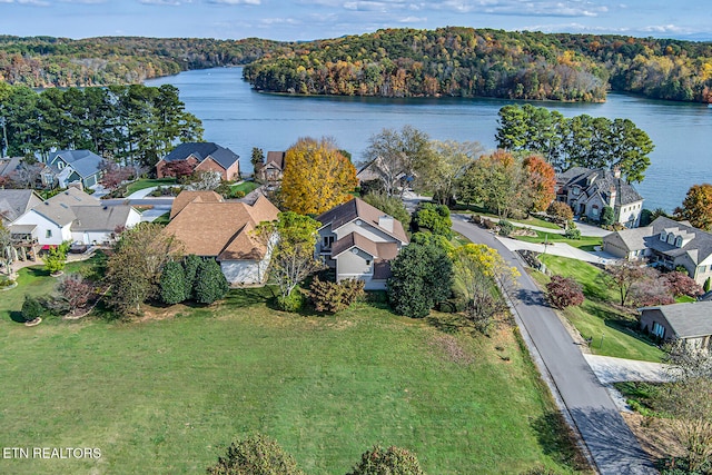 aerial view with a water view, a wooded view, and a residential view