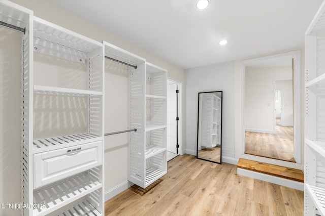 spacious closet with light hardwood / wood-style floors