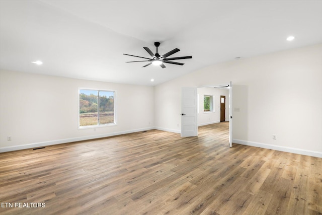 spare room with lofted ceiling, light hardwood / wood-style floors, and ceiling fan