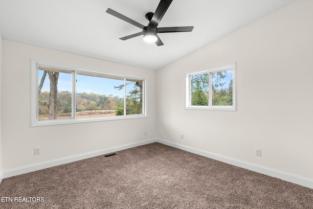 empty room featuring carpet floors, ceiling fan, and vaulted ceiling