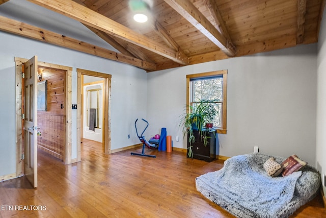 living area with lofted ceiling with beams, hardwood / wood-style flooring, and wooden ceiling