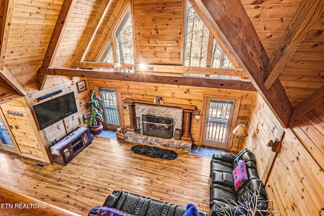 unfurnished living room with hardwood / wood-style flooring, a healthy amount of sunlight, and wooden ceiling