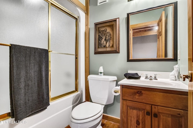 full bathroom with toilet, vanity, hardwood / wood-style flooring, and enclosed tub / shower combo