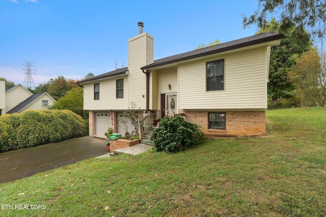 view of front of home featuring a front yard and a garage