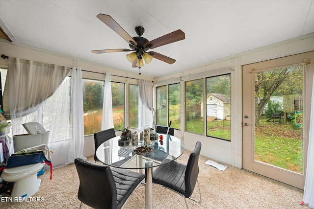 sunroom with plenty of natural light and ceiling fan