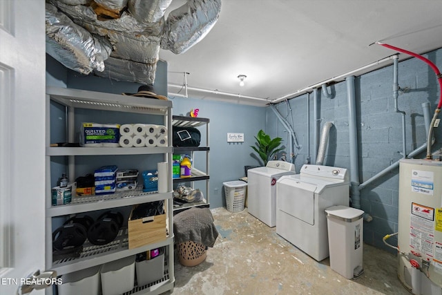 washroom featuring water heater and washing machine and clothes dryer