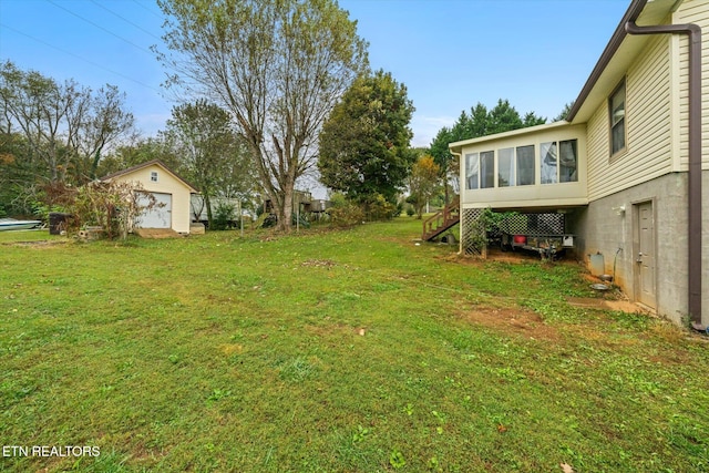 view of yard featuring an outbuilding and a sunroom