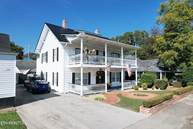 view of front of property featuring covered porch and a balcony