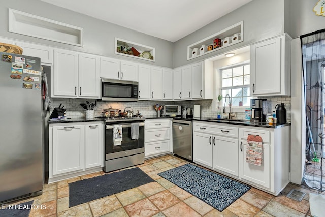 kitchen with sink, appliances with stainless steel finishes, and white cabinets