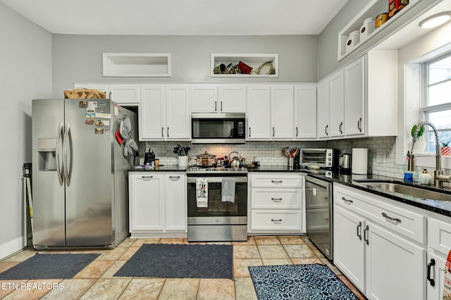 kitchen featuring white cabinetry, tasteful backsplash, stainless steel appliances, and sink