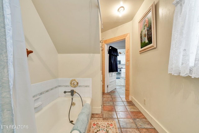 bathroom with a tub to relax in