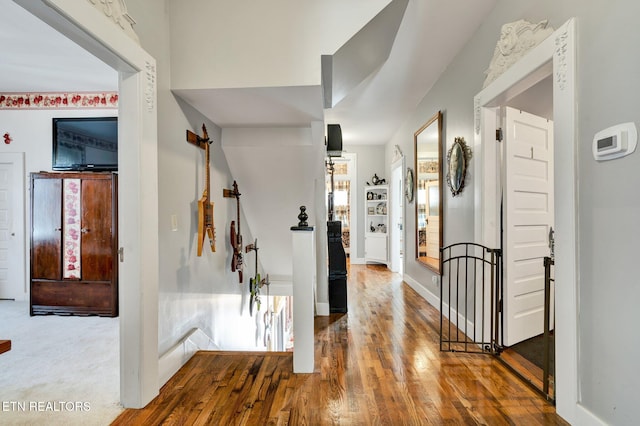 corridor with hardwood / wood-style flooring