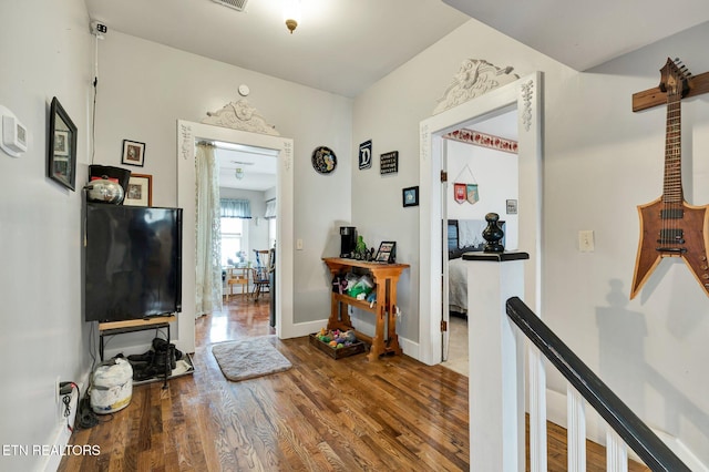 hall with hardwood / wood-style floors