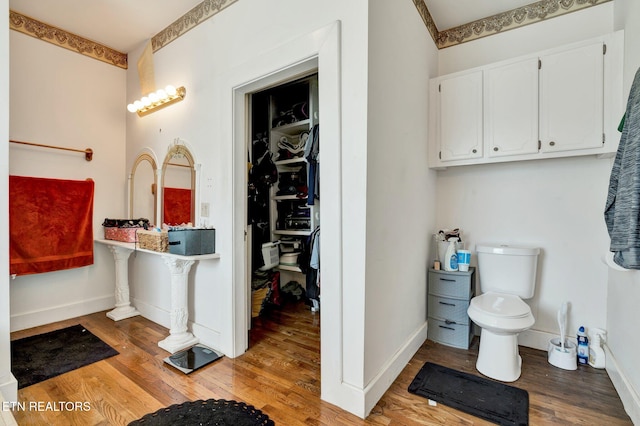 bathroom featuring hardwood / wood-style flooring and toilet