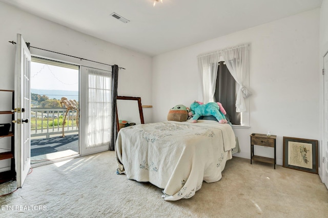 bedroom featuring french doors, light carpet, and access to outside