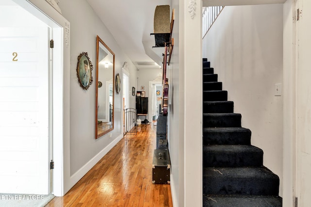 staircase featuring wood-type flooring