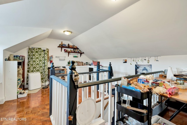 bonus room featuring vaulted ceiling and parquet floors