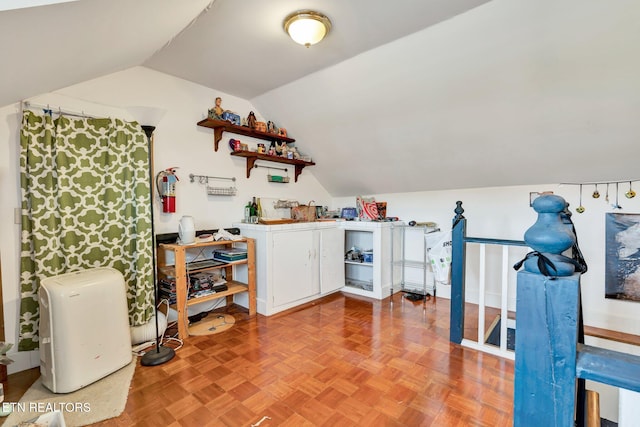 interior space featuring lofted ceiling and light parquet flooring