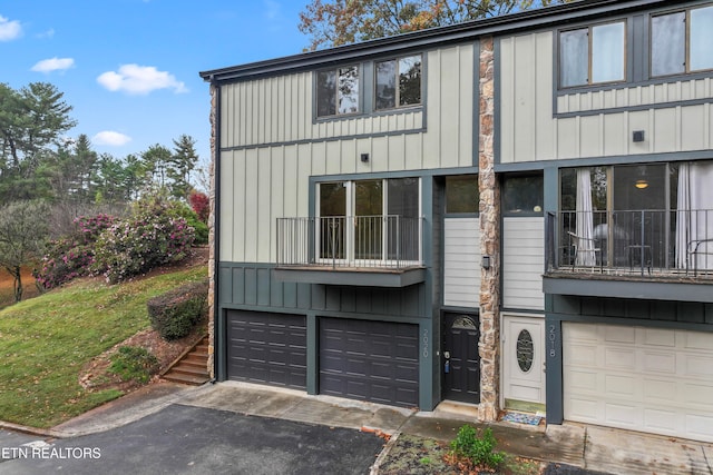 view of front of home with a garage and a balcony