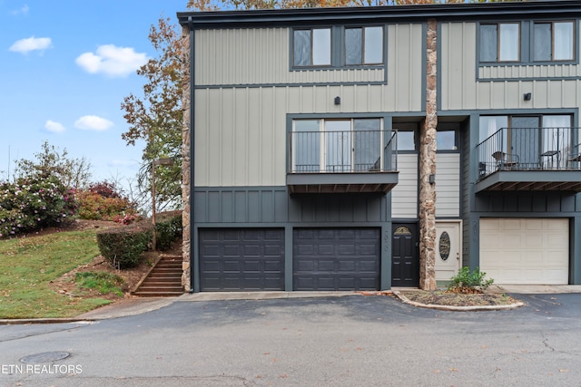 townhome / multi-family property with a garage and a balcony