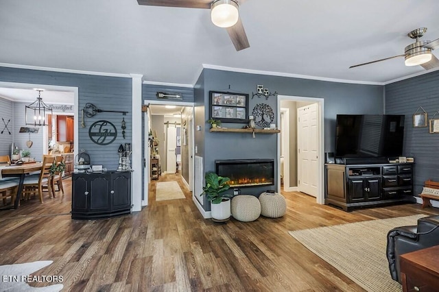 living room with crown molding, hardwood / wood-style flooring, and ceiling fan