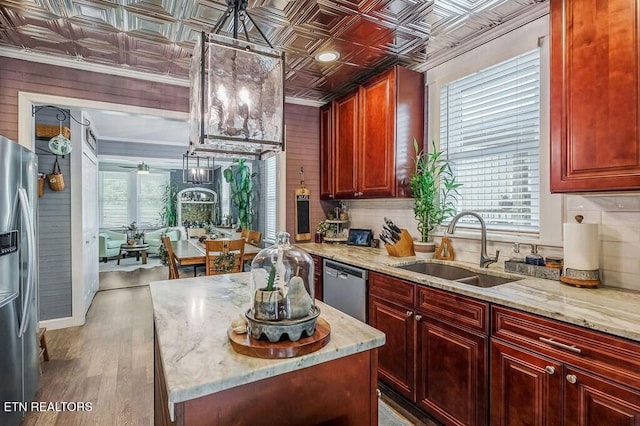 kitchen featuring light hardwood / wood-style floors, a healthy amount of sunlight, appliances with stainless steel finishes, and sink