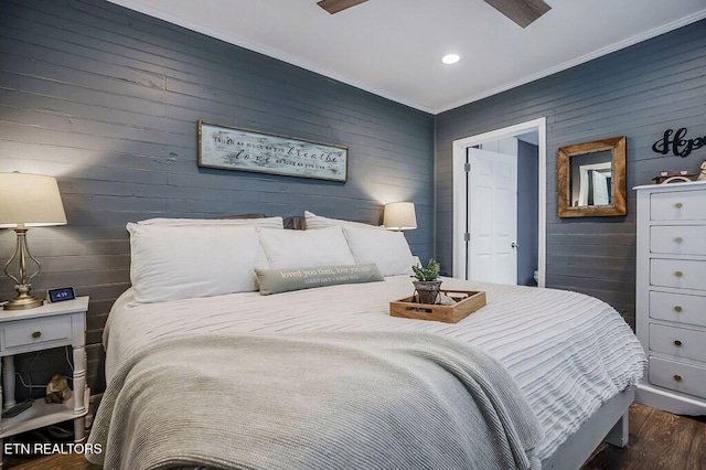 bedroom featuring crown molding, dark hardwood / wood-style floors, and ceiling fan