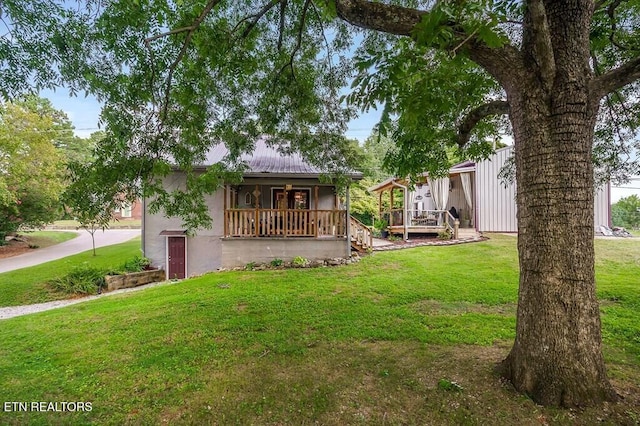 view of yard featuring covered porch