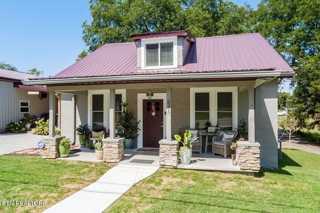 view of front of house featuring a front yard and covered porch