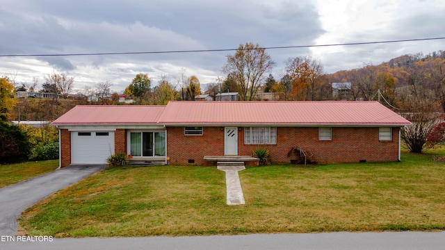 ranch-style house with a garage and a front lawn