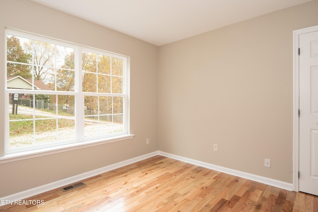 empty room with light hardwood / wood-style flooring