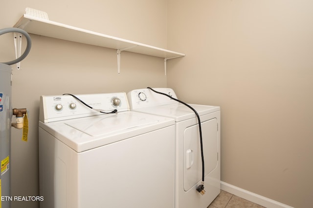 clothes washing area featuring separate washer and dryer and light tile patterned floors