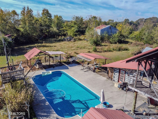 view of swimming pool featuring a lawn and a patio area