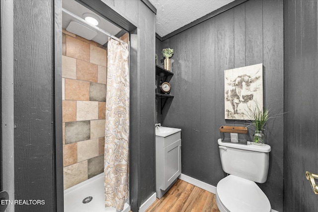 bathroom with curtained shower, wood-type flooring, toilet, and wood walls