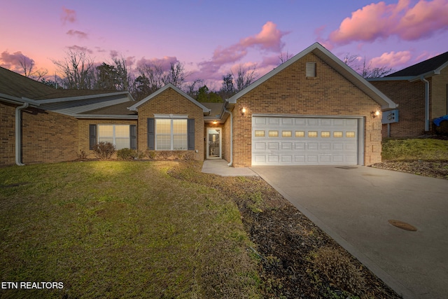 view of front facade with a garage and a yard