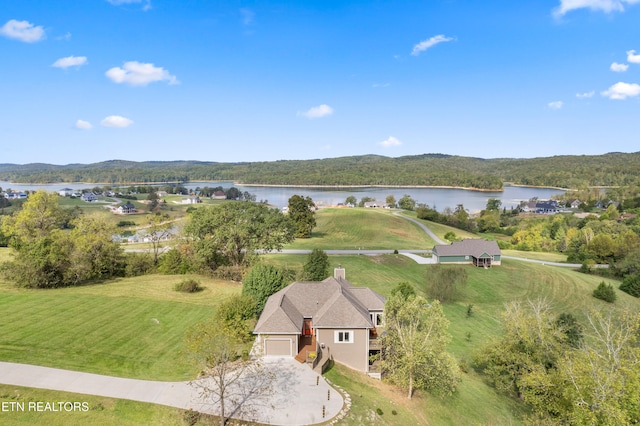 drone / aerial view featuring a water and mountain view