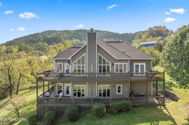 159 Garfield Ln, Sharps Chapel, TN 37866 - back of property featuring a chimney, a deck, a forest view, and a lawn