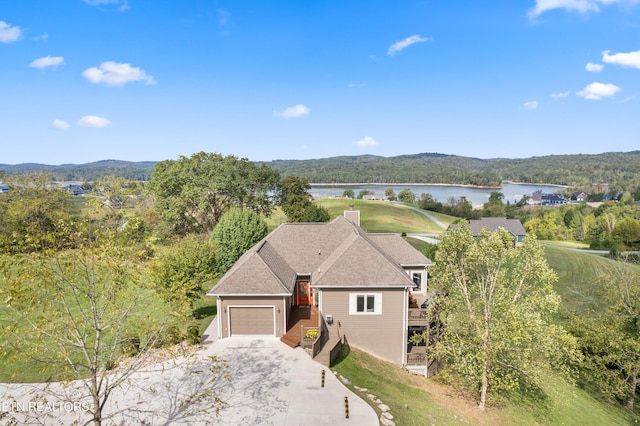 view of front of property featuring a garage and a water view