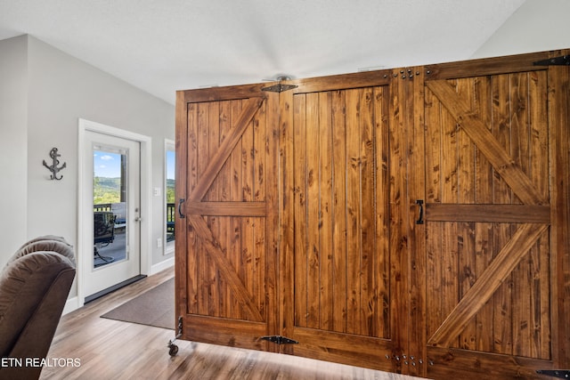 interior space featuring a barn door and hardwood / wood-style floors