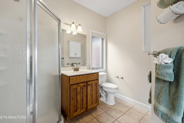 bathroom featuring vanity, tile patterned floors, toilet, and an enclosed shower