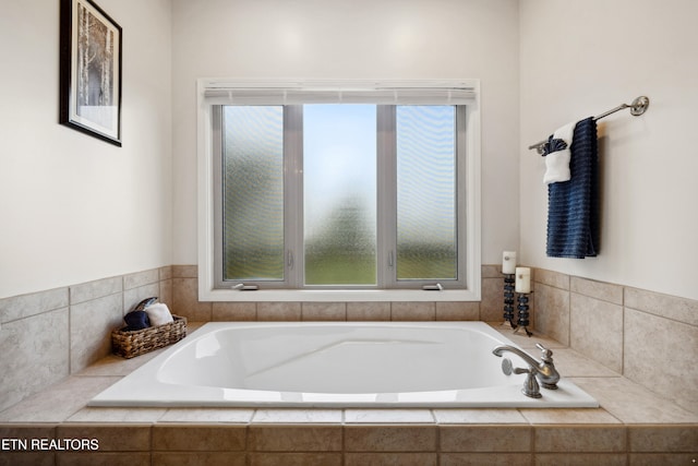 bathroom with tiled tub