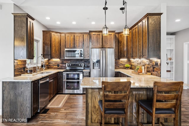 159 Garfield Ln, Sharps Chapel, TN 37866 - kitchen with appliances with stainless steel finishes, a sink, a peninsula, dark wood-style flooring, and light stone counters