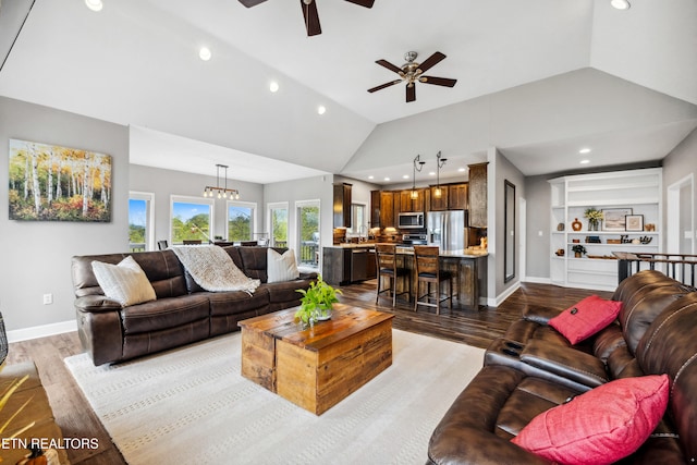 living room featuring ceiling fan with notable chandelier, light hardwood / wood-style floors, and high vaulted ceiling