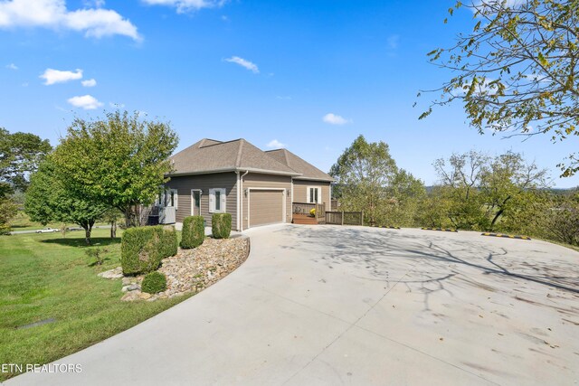 159 Garfield Ln, Sharps Chapel, TN 37866 - view of side of property featuring an attached garage, concrete driveway, a yard, and roof with shingles
