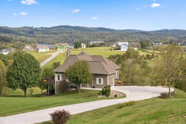 159 Garfield Ln, Sharps Chapel, TN 37866 - view of front of house featuring a front yard, concrete driveway, a deck with mountain view, and a garage