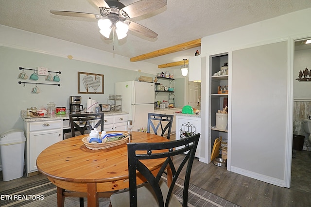 dining space with dark wood-type flooring, ceiling fan, and a textured ceiling